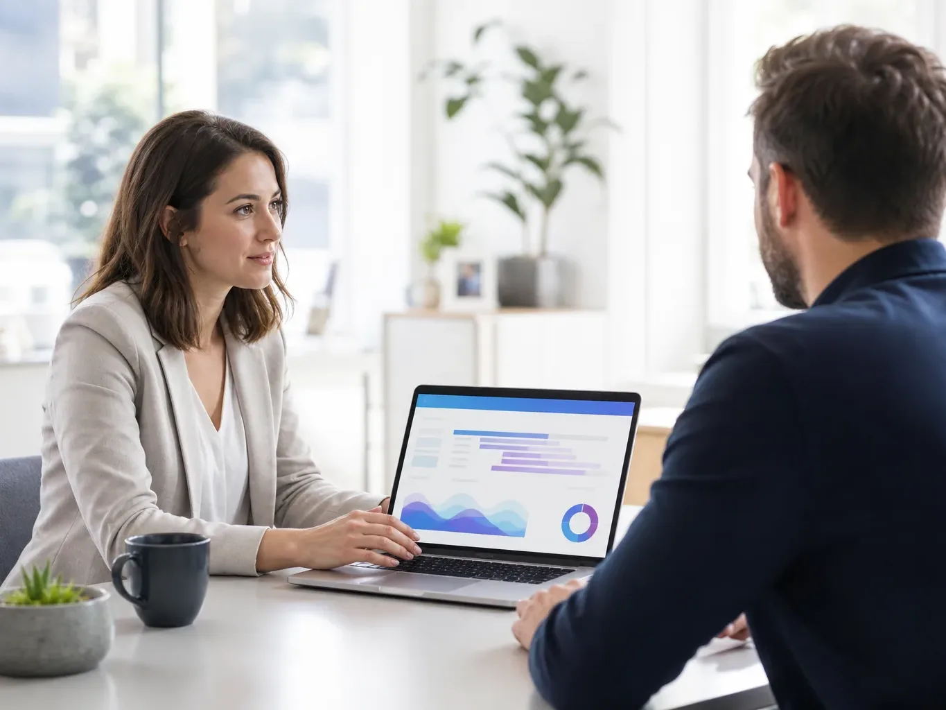 A reputation specialist and a client seated across a desk from each other in a quiet office